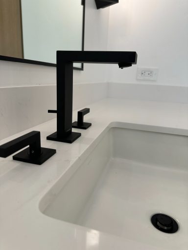 Rift cut white oak sanctuary Modern bathroom faucet in black finish with a minimalist sink design.